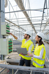 Two engineers inspecting construction site and looking involved