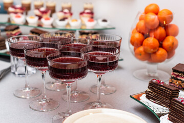 Elegant dessert table featuring fruit, sweets, and sparkling beverages at a festive celebration