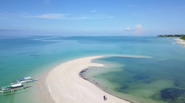 Frontal tracking shot of an incredible stretch of sand over the clearest sea in the world on Bantayan Island, Phillipines