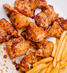 Delicious grilled chicken served with crispy fries at dinner
