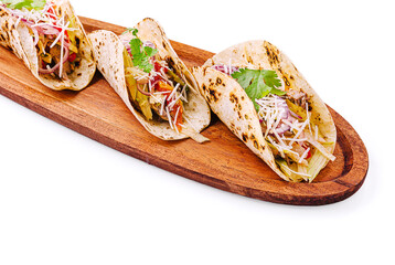 Flavorful tacos served on a wooden board with fresh ingredients