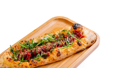 Savory flatbread topped with fresh ingredients on a wooden board
