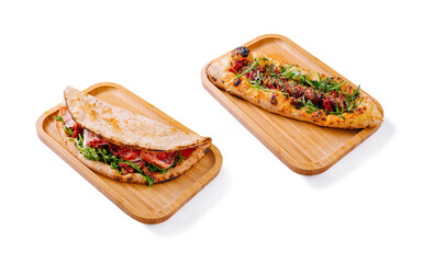 Tasty flatbreads with meat and veggies on wooden trays