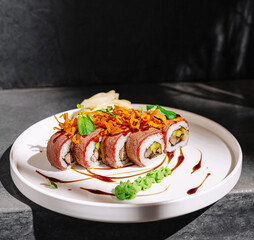 Delicious sushi rolls with savory toppings on a white plate