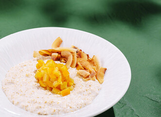 Breakfast bowl with creamy oats, mango, and coconut flakes served