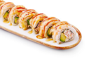 Delicious sushi roll with avocado and toppings served in a restaurant