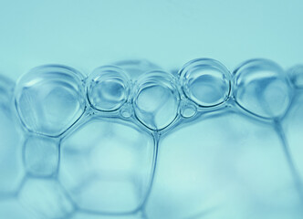 macrophotography of bubbles in blue water