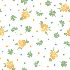 Obraz premium Seamless spring background with yellow flowers and green clover leaves, and color dots. Pattern design for card, textile.
