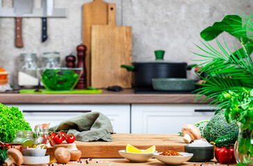Healthy vegan eating, cooking, food blogging banner background. Empty oak cutting board with mushrooms, tomatoes, vegetables and spices on cozy kitchen with kitchenware and utensils
