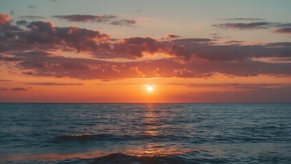 Obraz premium Tranquil sunset over the ocean with vibrant colors reflecting on the water, ideal for vacation and travel themed visuals.