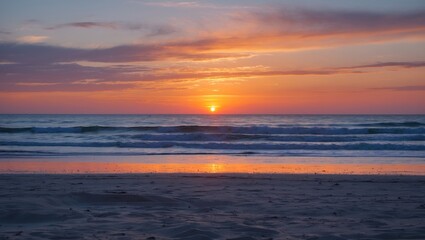 Naklejka premium Vibrant Sunset Over Tranquil Beach with Soft Waves and Golden Reflection on Sand