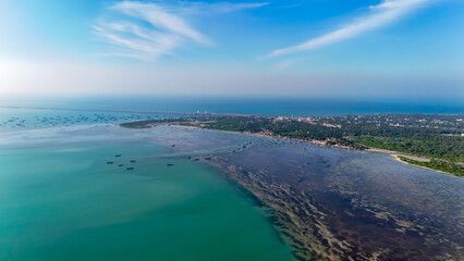 Stunning drone photograph of the Pamban Bridge at sunset, as the last rays of sunlight create a magical glow over the bridge and the surrounding ocean.