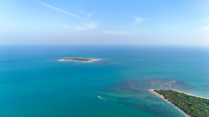 A stunning aerial view of a small island surrounded by the vast expanse of the Indian Ocean. 