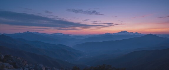 Obraz premium Serene Twilight View Over Mountain Range with Soft Sky Colors Creating a Tranquil and Relaxing Atmosphere