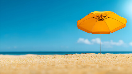 Yellow Beach Umbrella on Sandy Beach Under Blue Sky in Bright Sunlight