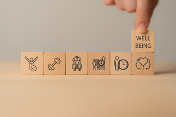 Employee wellbeing concept. Wooden blocks with physical, mental, emotional health icons. Creating employee benefits, satisfaction programs. Fostering positive work culture, employee engagement.