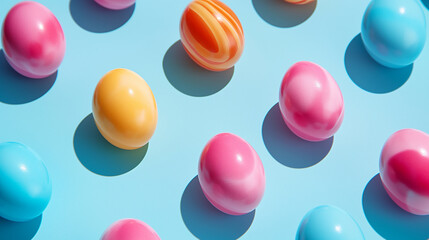 Fototapeta premium A blue background with colorful Easter eggs, celebrating the festive theme of Easter with vibrant, seasonal decoration