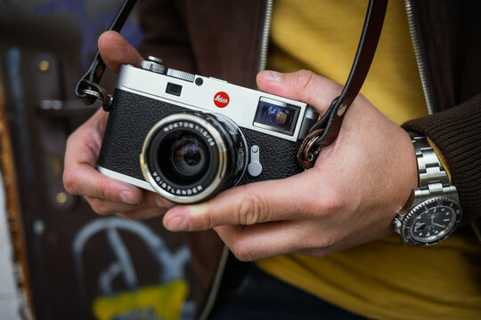 Photographer holding an iconic Leica camera
