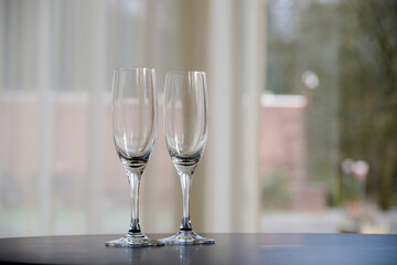 Two empty glasses of Champagne on table after party