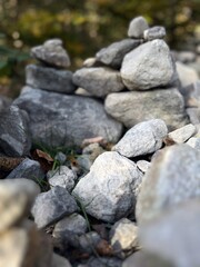 A carefully stacked stone cairn in a peaceful forest setting, symbolizing balance, mindfulness, and meditation. A perfect nature-inspired image for wellness, travel, and outdoor adventure themes	