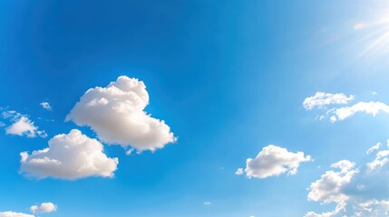 Heart-shaped clouds float serenely in a vibrant blue sky
