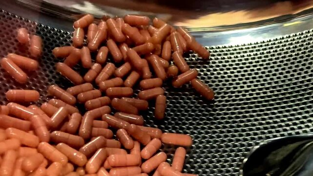 Automatic capsule tablet production line in pharmaceutical factory, Rotating machine Capsule medicine pills in the workshop of chemical factory.