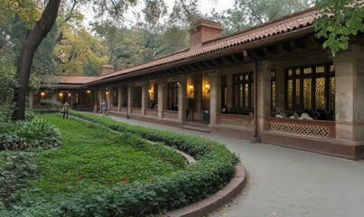Obraz premium Terracotta Building with Lush Green Landscaping and a Curving Pathway