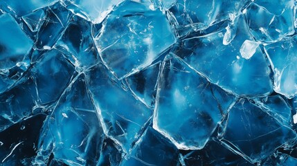 Close-up of cracked ice with deep blue tones and sharp details. A perfect winter texture for backgrounds and design projects.