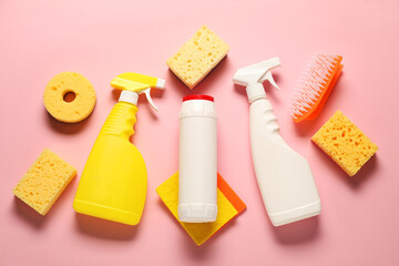 Cleaning products and tools on pink background, flat lay