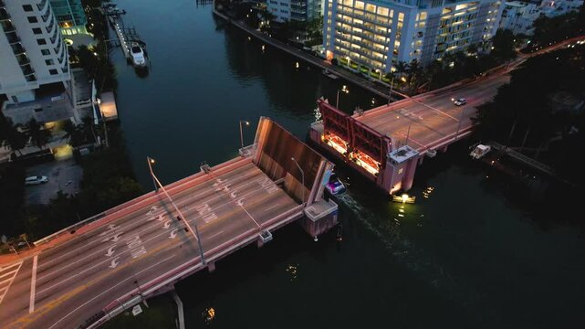 Miami Beach, Florida - Aerial view of a drawbridge at North Beach, with a boat passing through the open gateway.