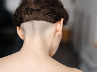 Close-up of a beautiful girl's haircut with a bare back of the head.