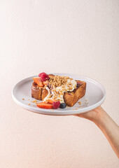 Deliciously plated French toast topped with fresh fruits, yogurt, and granola, showcasing a vibrant breakfast experience, healthy eating concept