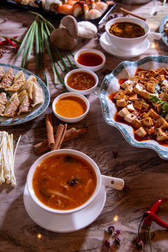 Gourmet Asian Food Platter Featuring Hot and Sour Soup, Dumplings, and Tofu