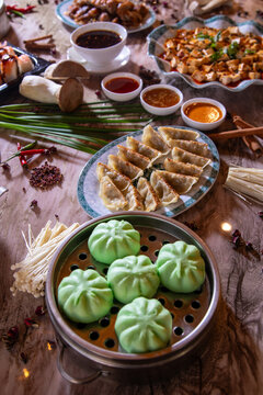 Gourmet Asian Food Platter Featuring Hot and Sour Soup, Dumplings, and Tofu