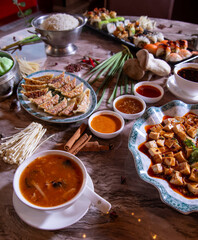 Gourmet Asian Food Platter Featuring Hot and Sour Soup, Dumplings, and Tofu
