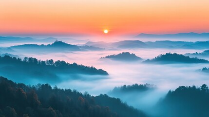 Obraz premium A dramatic sunrise over a peaceful foggy valley, symbolizing new beginnings.