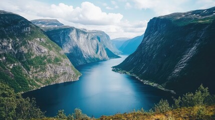 A stunning fjord landscape with towering cliffs, deep blue waters, and dramatic lighting.