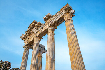 The scenic view of the Temple of Apollo on the antique side is at the far end of the peninsula, next to the ancient port built in the 2nd century A.D. in Side, Antalya, Turkey.