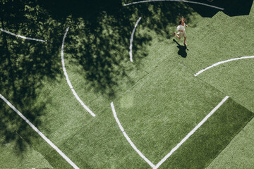 Aerial View of Person Walking on Sports Field