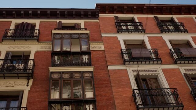 view of Traditional residential building's facade under blue sky in the Chueca neighborhood