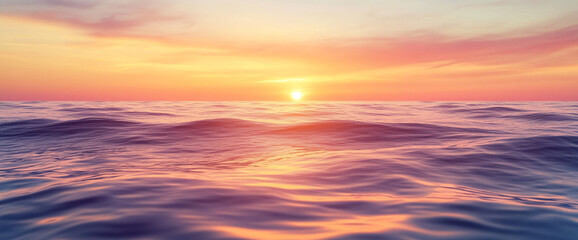 Fototapeta premium Serene ocean waves at sunset, with soft ripples on the water surface, symbolizing tranquility, nature, and peaceful moments. The warm golden light adds a sense of calm and beauty.