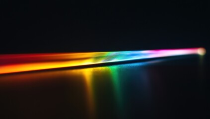 Obraz premium Colorful light beam reflecting on dark surface.