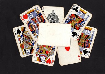A montage of vintage playing cards behind a blank card with space for text.