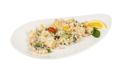 A white plate with a colorful salad and a slice of lemon