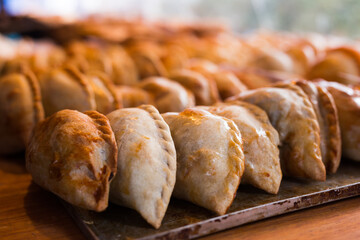 Freshly baked empanadas with different fillings for sale