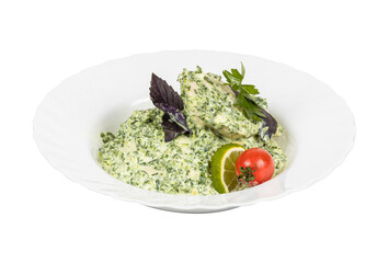 A white plate with salad and a tomato on a white background