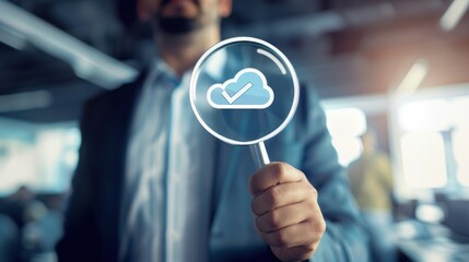 Business professional holds a magnifying glass with a cloud icon in a modern office setting during a corporate meeting about digital solutions