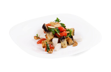 A white plate topped with a vibrant salad of fresh veggies and nuts