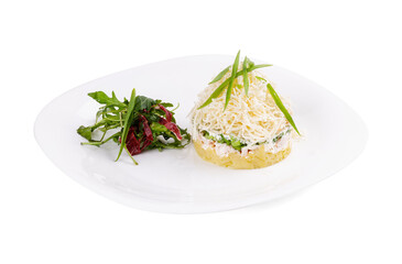 A white plate with a salad and a sandwich on a white background