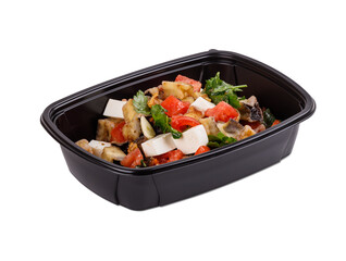 A black container filled with various foods on a white background